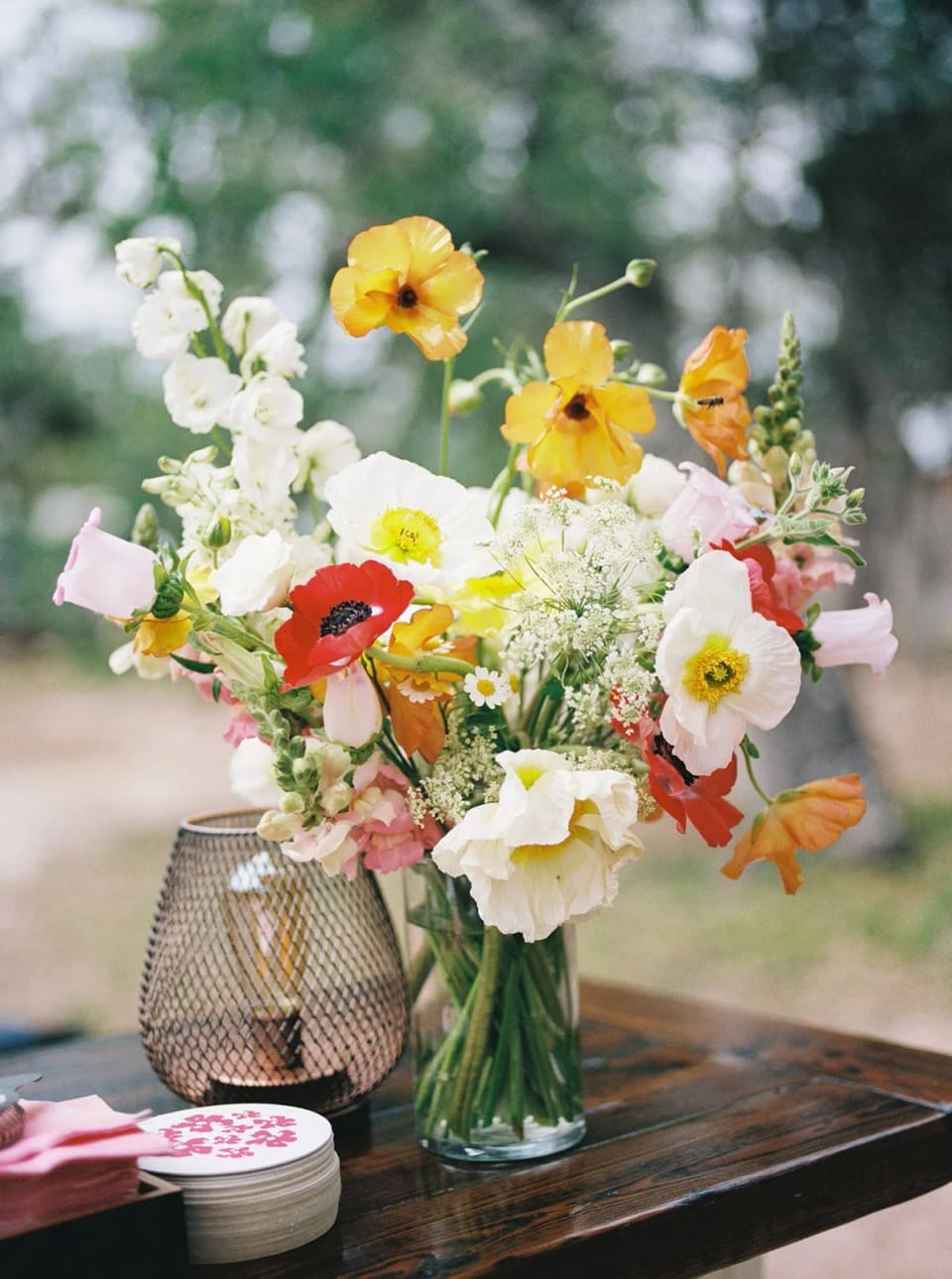 Wild garden-style centerpiece with poppies and ranunculus